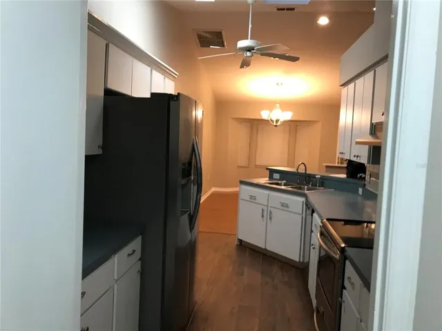 a kitchen with a refrigerator and a sink