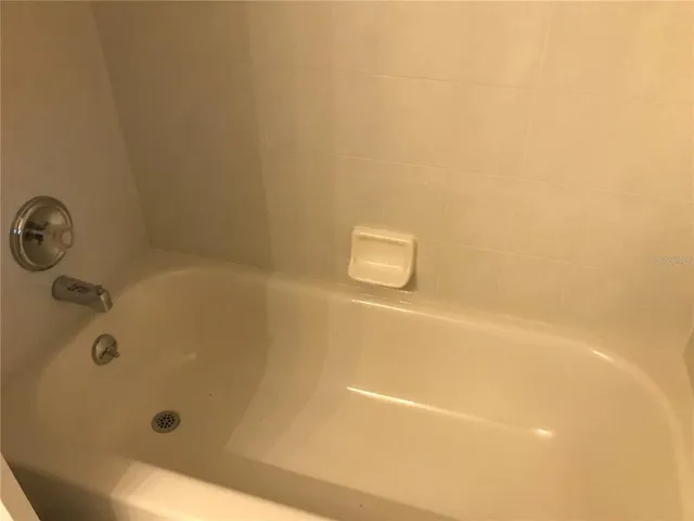 a view of a room with a chandelier fan and a window