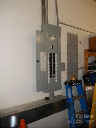 a bathroom with a refrigerator and a shower