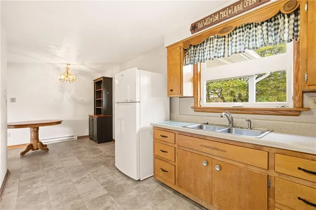 a kitchen with a refrigerator and a sink
