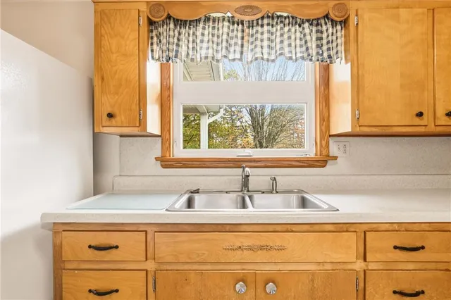 a bathroom with a sink and a window