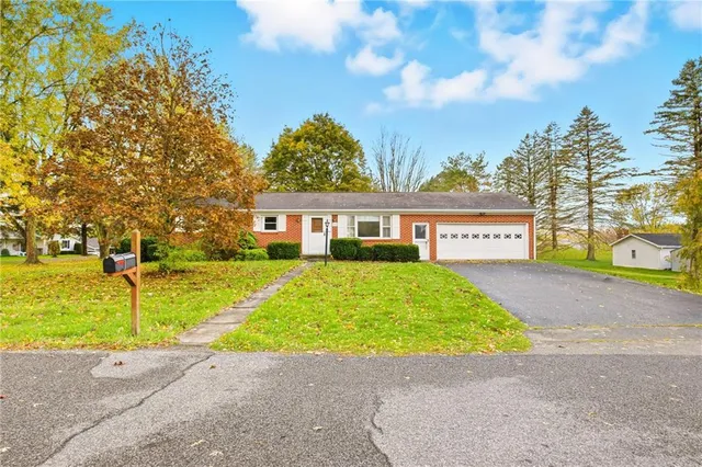 a sign board with yard in front of it