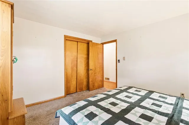 a bedroom with a bed and a cabinet