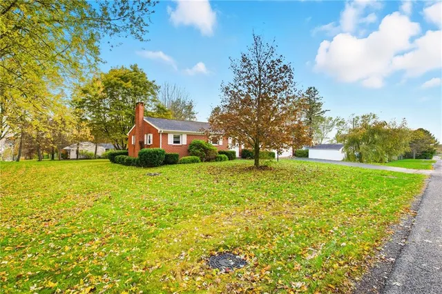 a front view of house with yard and trees