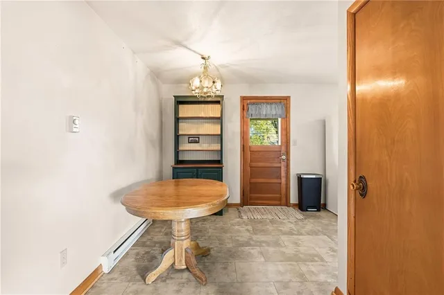an empty room with a table and chandelier