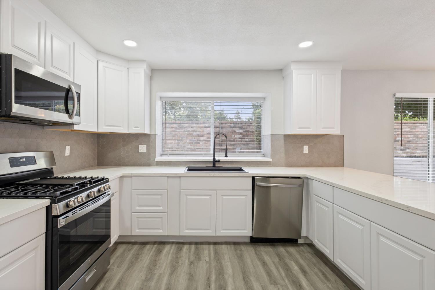 7300 Saltgrass Way Elk Grove, CA 95758 - Photo 12 of 35 a kitchen with stainless steel appliances a sink dishwasher a stove and microwave