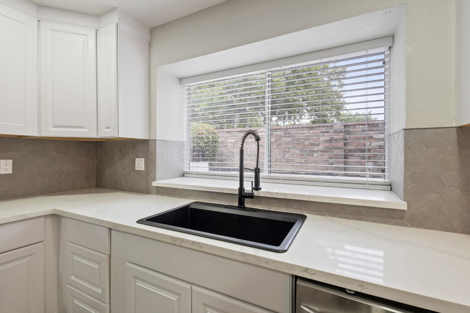 7300 Saltgrass Way Elk Grove, CA 95758 - Photo 13 of 35 a kitchen with granite countertop white cabinets and a sink