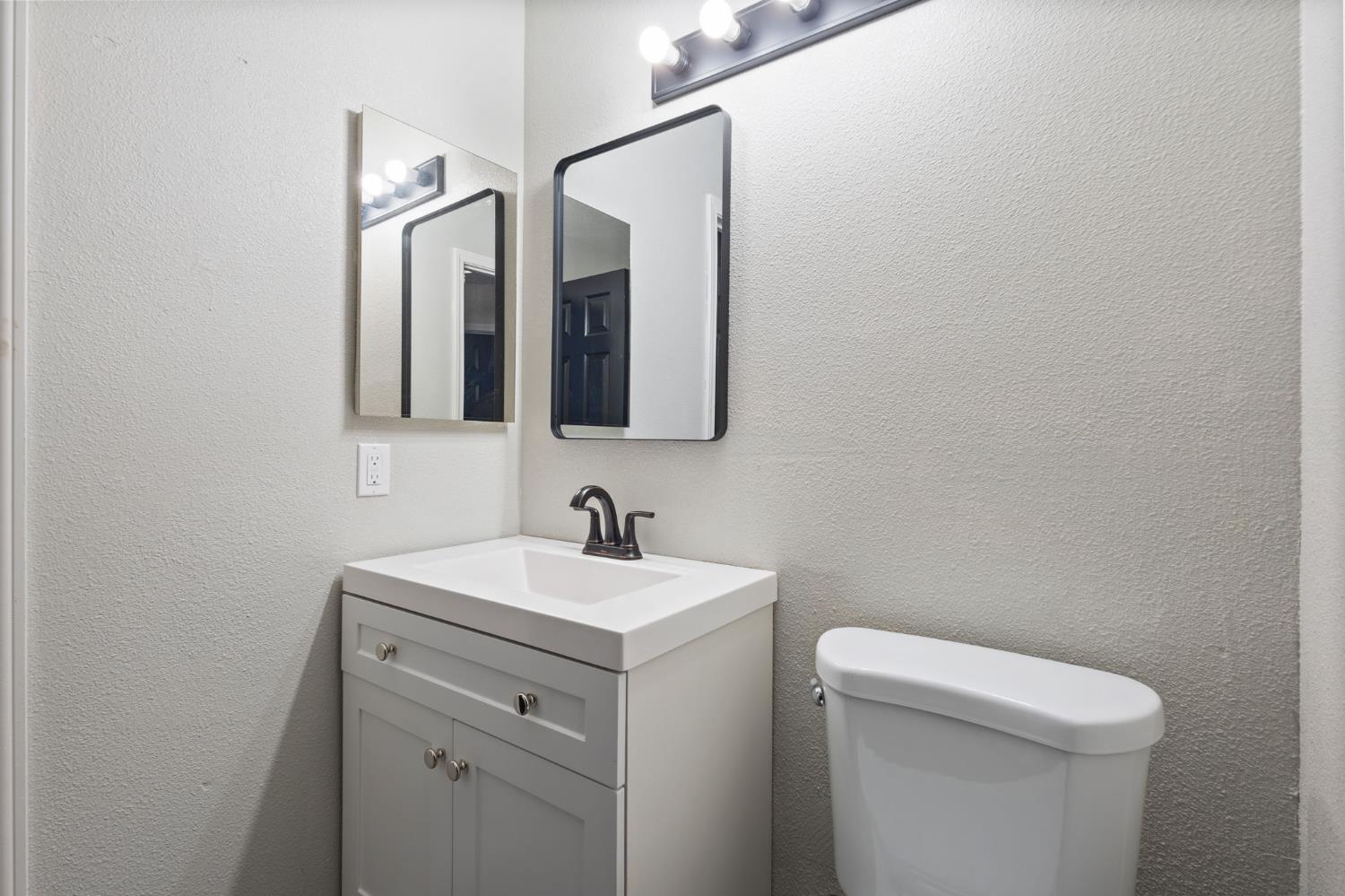 7300 Saltgrass Way Elk Grove, CA 95758 - Photo 19 of 35 a bathroom with a toilet sink and mirror