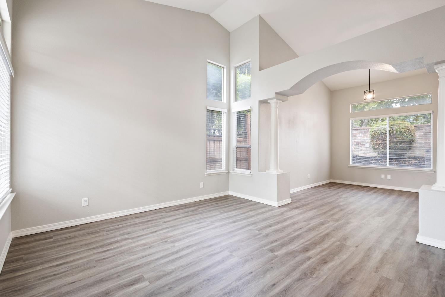 7300 Saltgrass Way Elk Grove, CA 95758 - Photo 5 of 35 an empty room with wooden floor and windows