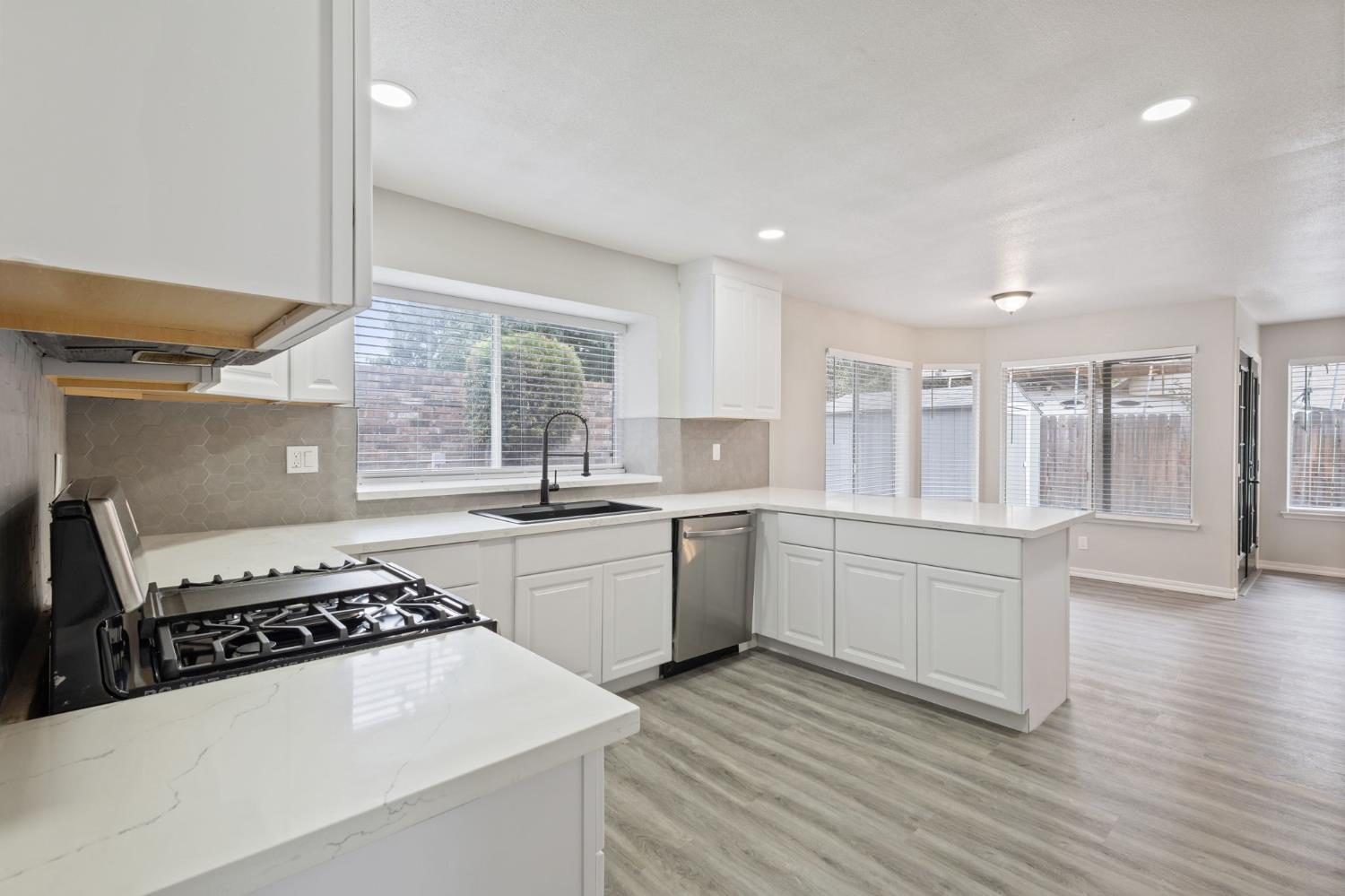 7300 Saltgrass Way Elk Grove, CA 95758 - Photo 10 of 35 a kitchen with sink a stove and wooden floor