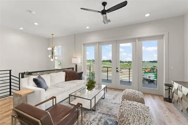 a front view of a house with a garden and lake view