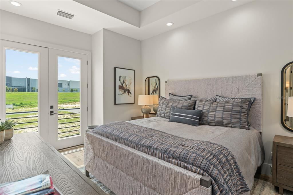 396 Chicane Circle, Unit 5 Auburndale, FL 33823 - Photo 20 of 62 a bedroom with a bed and wooden floor