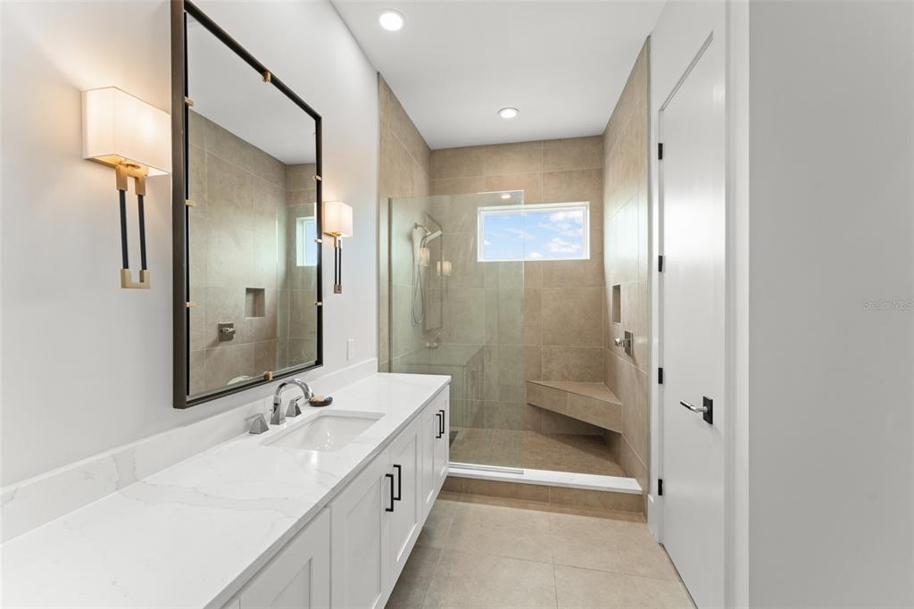 396 Chicane Circle, Unit 5 Auburndale, FL 33823 - Photo 22 of 62 a bathroom with a double vanity sink mirror and shower
