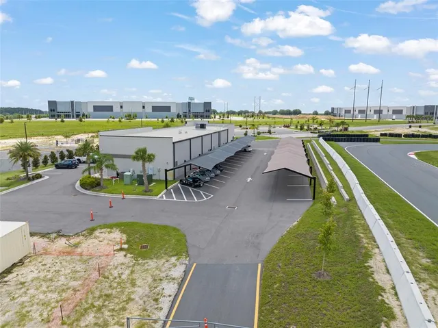 a kitchen with stainless steel appliances kitchen island granite countertop a stove a sink a dining table and chairs with wooden floor