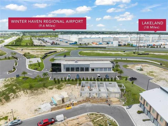 a kitchen with stainless steel appliances granite countertop a stove a refrigerator a sink a dining table and chairs