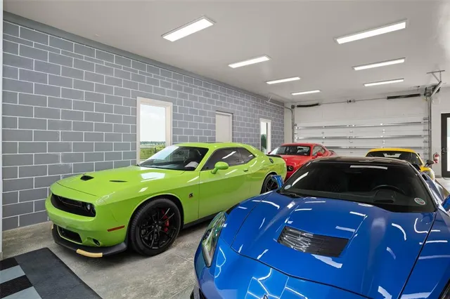 a bedroom with bed and a car parked