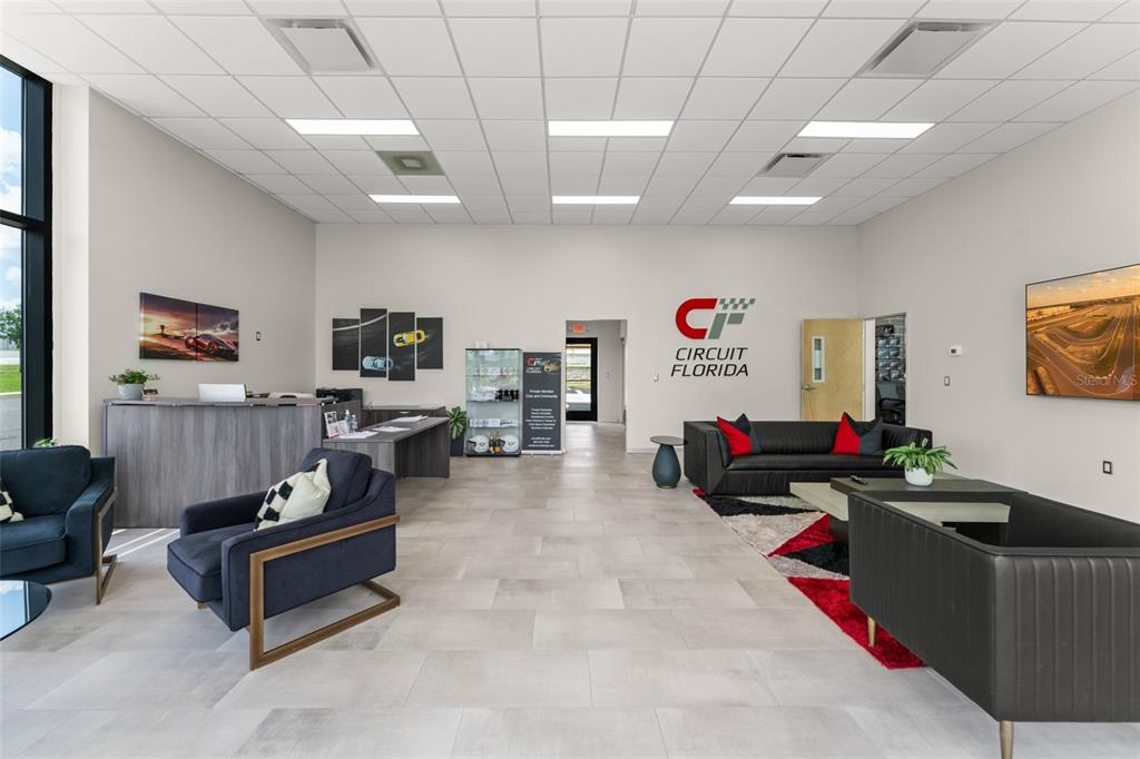 396 Chicane Circle, Unit 5 Auburndale, FL 33823 - Photo 56 of 62 a living room with furniture and a flat screen tv