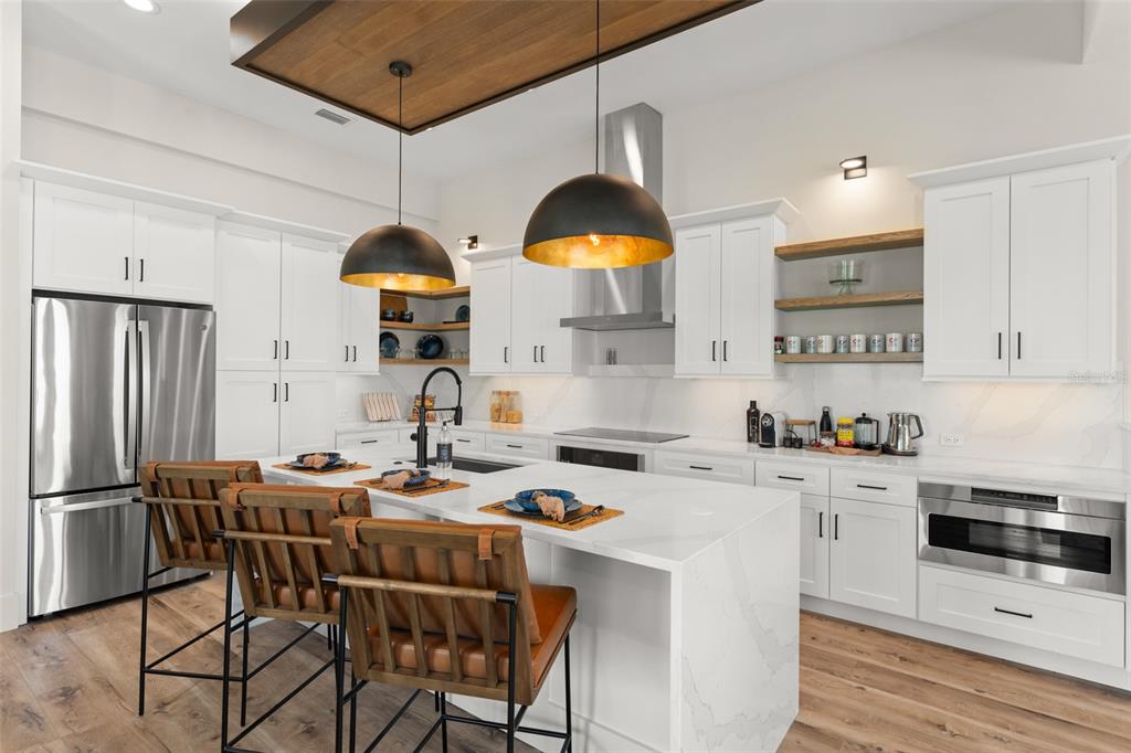 396 Chicane Circle, Unit 5 Auburndale, FL 33823 - Photo 8 of 62 a kitchen with stainless steel appliances granite countertop a stove a refrigerator a sink a dining table and chairs