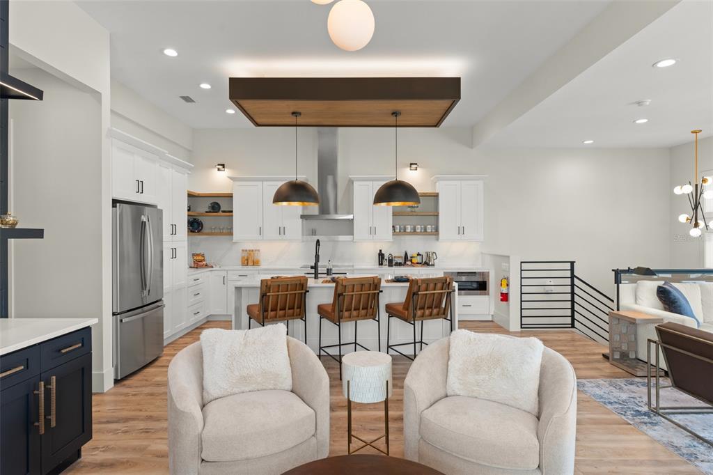 396 Chicane Circle, Unit 5 Auburndale, FL 33823 - Photo 9 of 62 a living room with stainless steel appliances kitchen island granite countertop a dining table chairs and a refrigerator