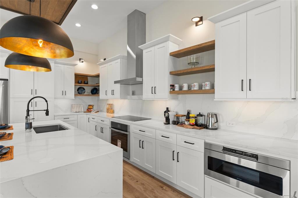 396 Chicane Circle, Unit 5 Auburndale, FL 33823 - Photo 10 of 62 a kitchen with white cabinets and appliances