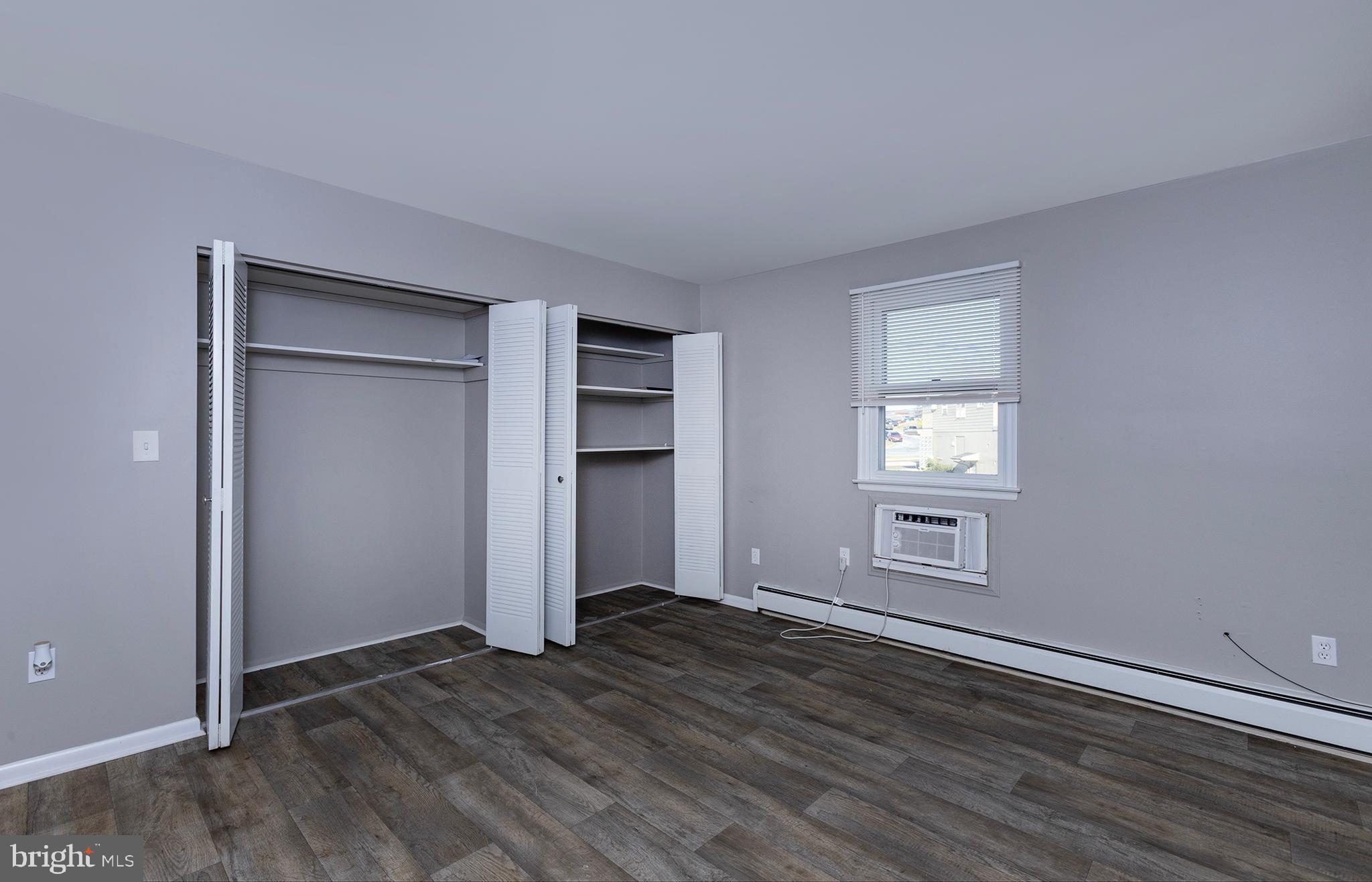 110 Sunset Avenue, Unit 201 Harrisburg, PA 17112 - Photo 12 of 22 an empty room with wooden floor closet and windows
