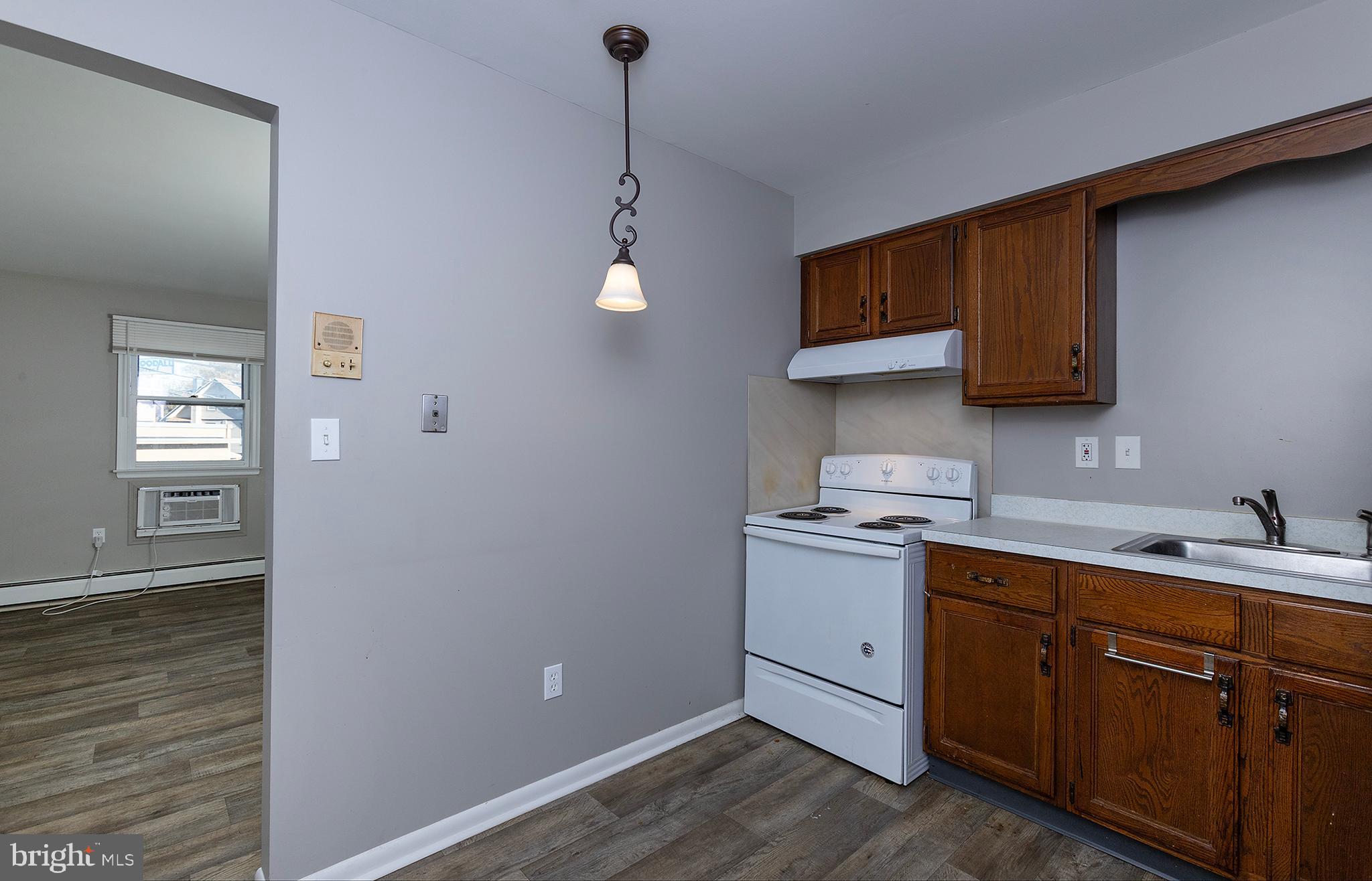 110 Sunset Avenue, Unit 201 Harrisburg, PA 17112 - Photo 5 of 22 a kitchen with a sink cabinets and wooden floor