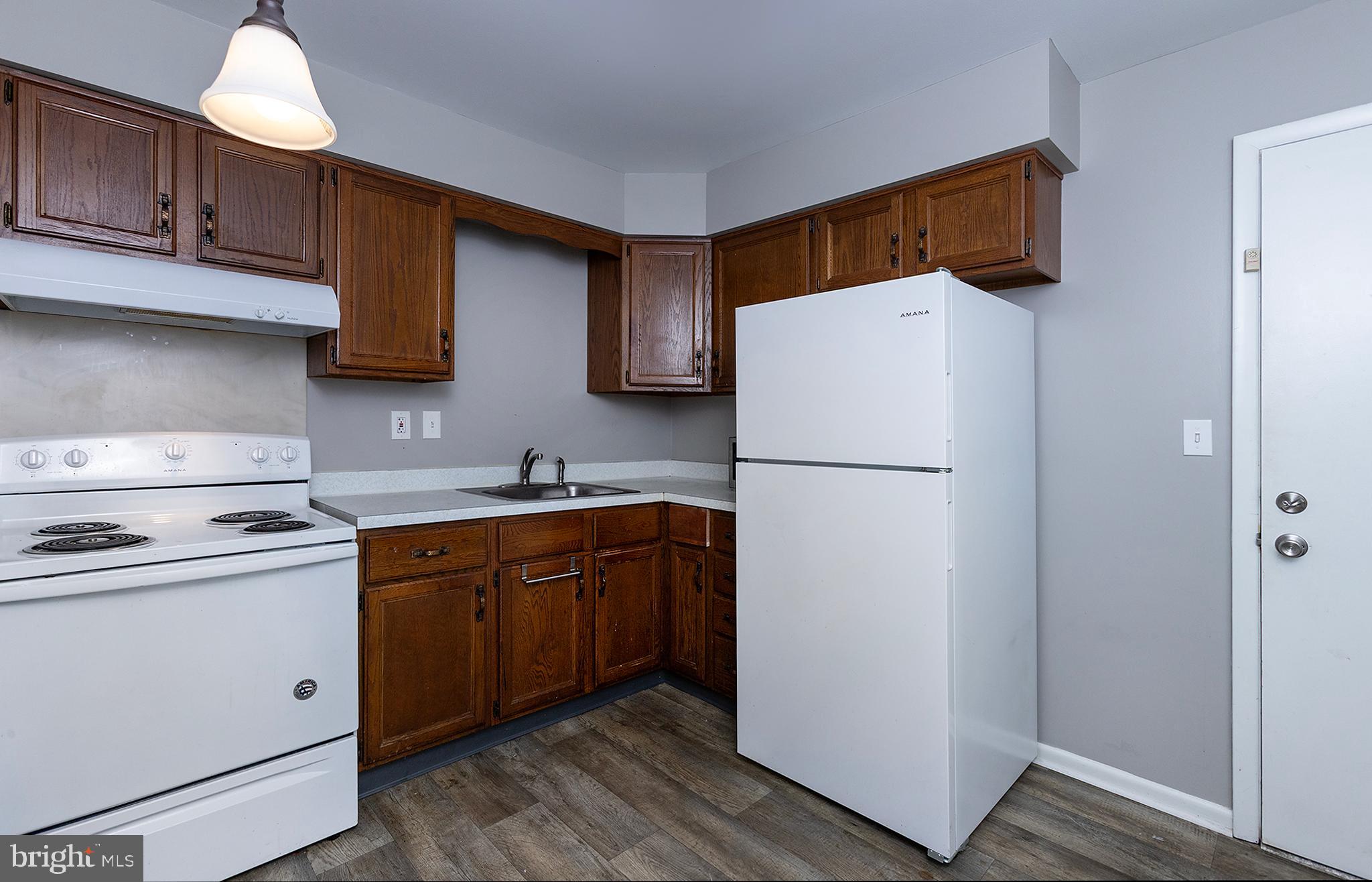 110 Sunset Avenue, Unit 201 Harrisburg, PA 17112 - Photo 6 of 22 a kitchen with stainless steel appliances granite countertop a refrigerator stove a sink and dishwasher