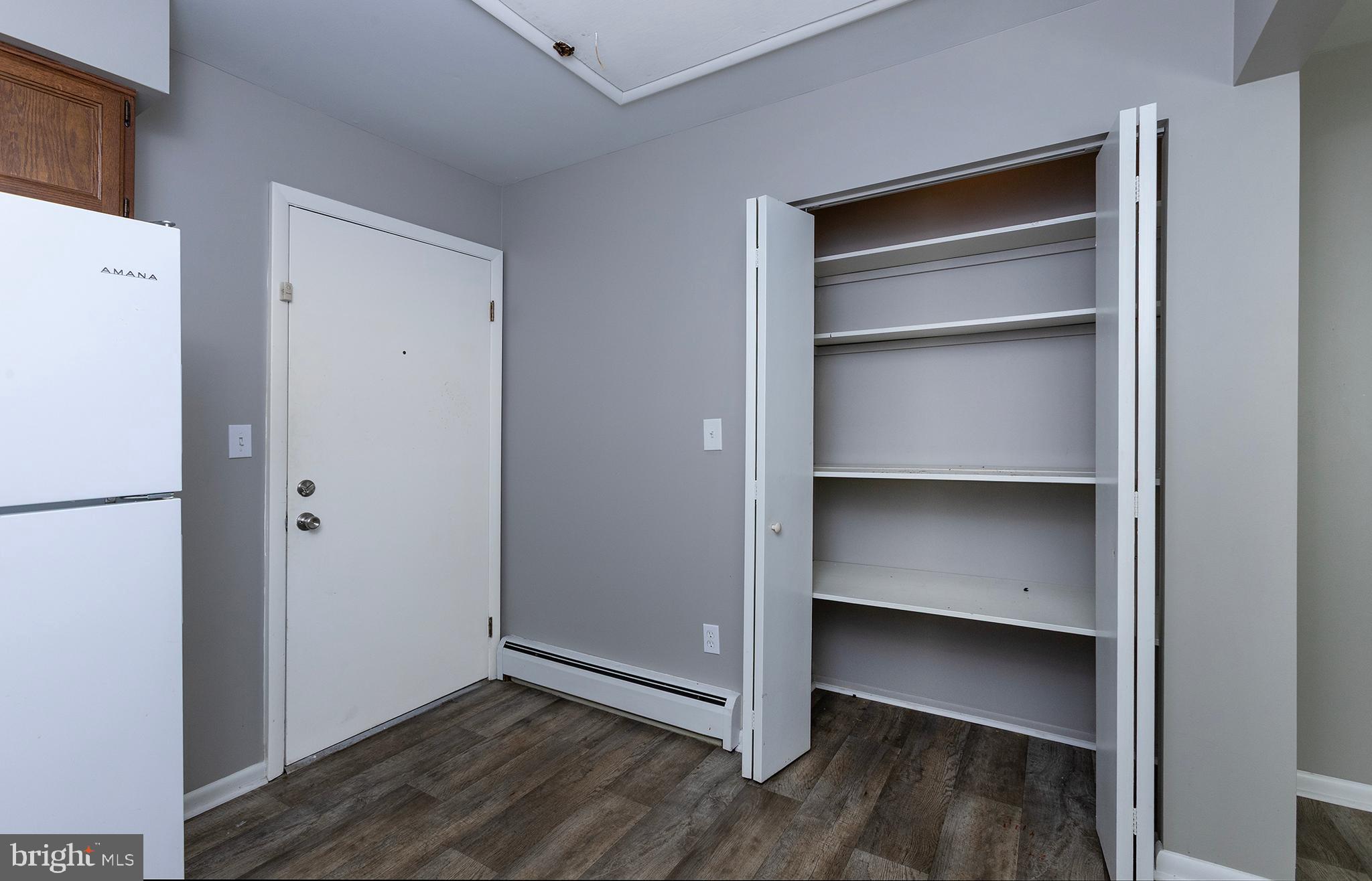 110 Sunset Avenue, Unit 201 Harrisburg, PA 17112 - Photo 8 of 22 a view of an empty room with wooden floor & closet