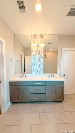 a bathroom with a sink mirror and a bathtub
