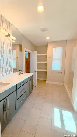 a bathroom with a sink a vanity and a bathtub