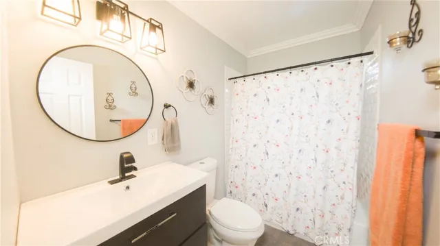 a bathroom with a sink a mirror a toilet and a mirror