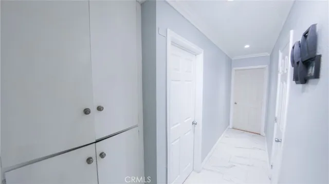 a view of a hallway with flat screen tv