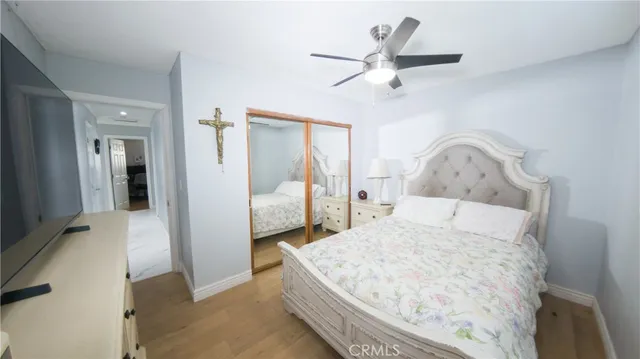 a bedroom with a bed and a ceiling fan