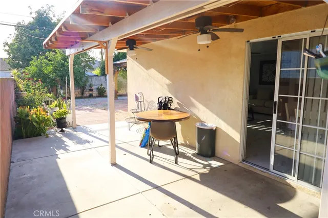a view of a porch with furniture and front view of a house