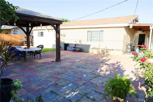 a view of a porch with furniture and floor to ceiling window