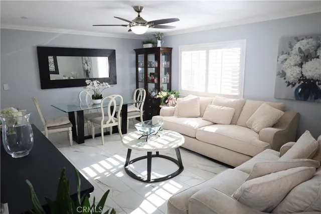 a living room with furniture a window and a chandelier
