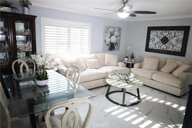 a living room with furniture a bed and a chandelier