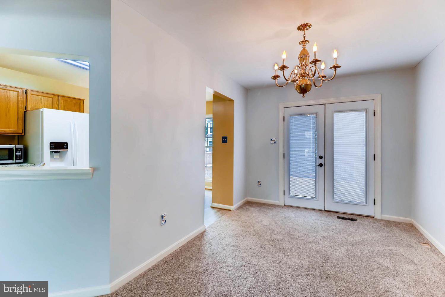 4414 Cole Farm Road Baltimore, MD 21236 - Photo 8 of 30 wooden floor in an entryway with a chandelier