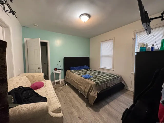 a bedroom with a bed and a lamp