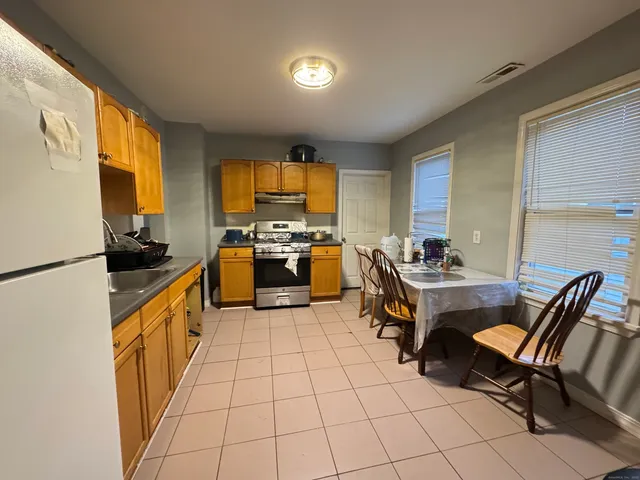 a kitchen with a sink a stove top oven and cabinetry