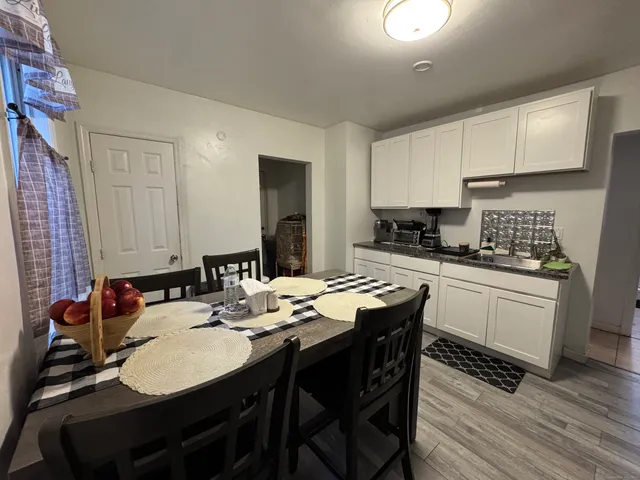 a kitchen with a sink cabinets and wooden floor