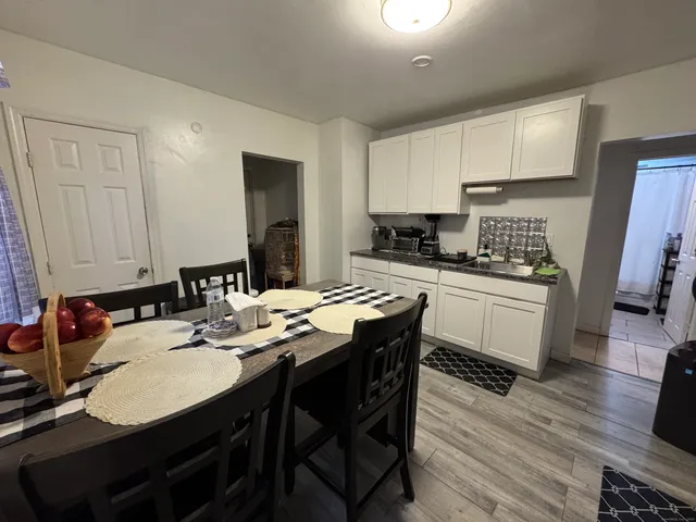 a kitchen with a dining table cabinets and appliances