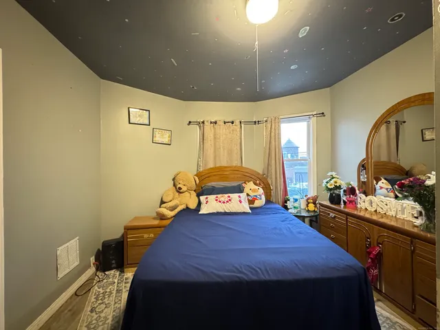 a bedroom with bed and window