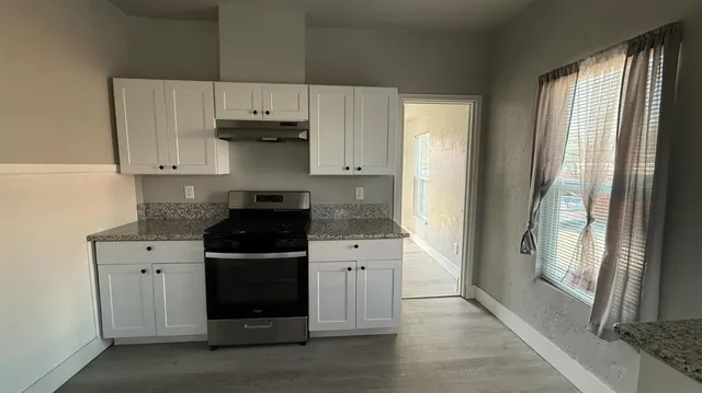 a kitchen with a stove and a refrigerator