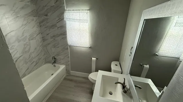 a bathroom with a bathtub sink and toilet