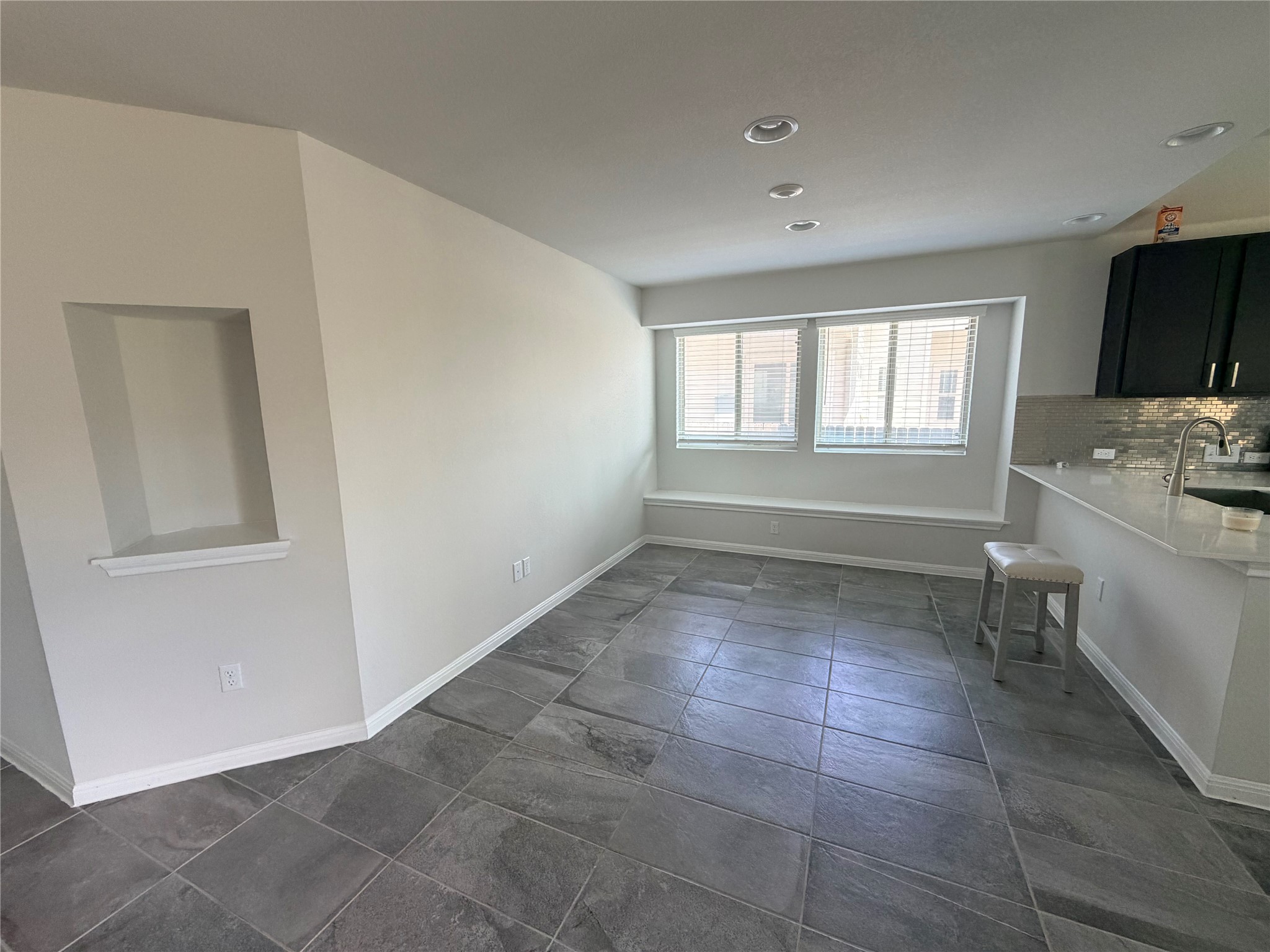 2813 Hopi Path, Unit 11 Leander, TX 78641 - Photo 17 of 17 Unfurnished dining area with baseboards and dark stone finish floors