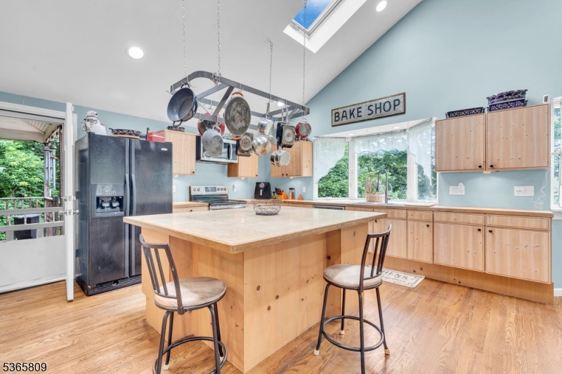 9 Mueller Lane Washington, NJ 07882 - Photo 14 of 45 a kitchen with stainless steel appliances kitchen island a table chairs in it and wooden floors