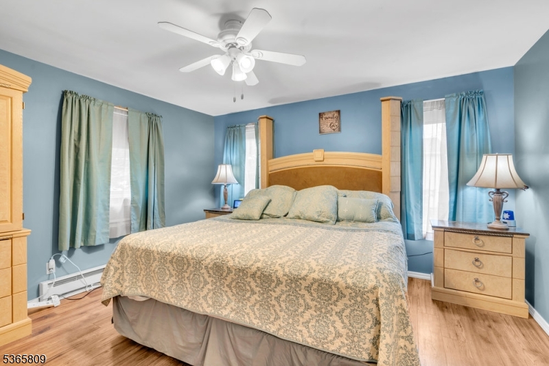 9 Mueller Lane Washington, NJ 07882 - Photo 21 of 45 a bedroom with a large bed and a chandelier