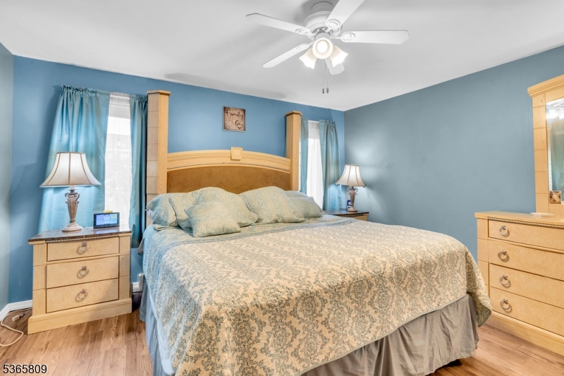 9 Mueller Lane Washington, NJ 07882 - Photo 22 of 45 a bedroom with a bed and wooden floor