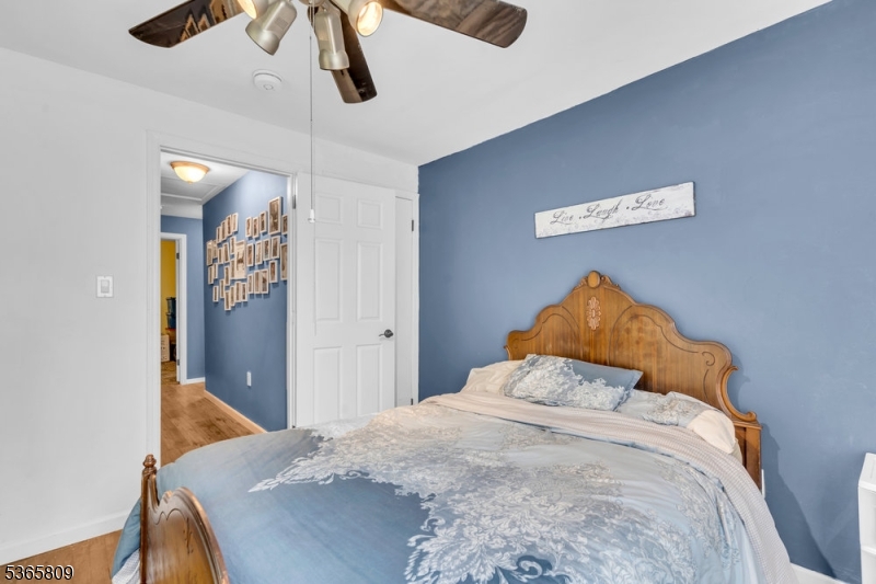 9 Mueller Lane Washington, NJ 07882 - Photo 24 of 45 a bedroom with a bed and a chandelier